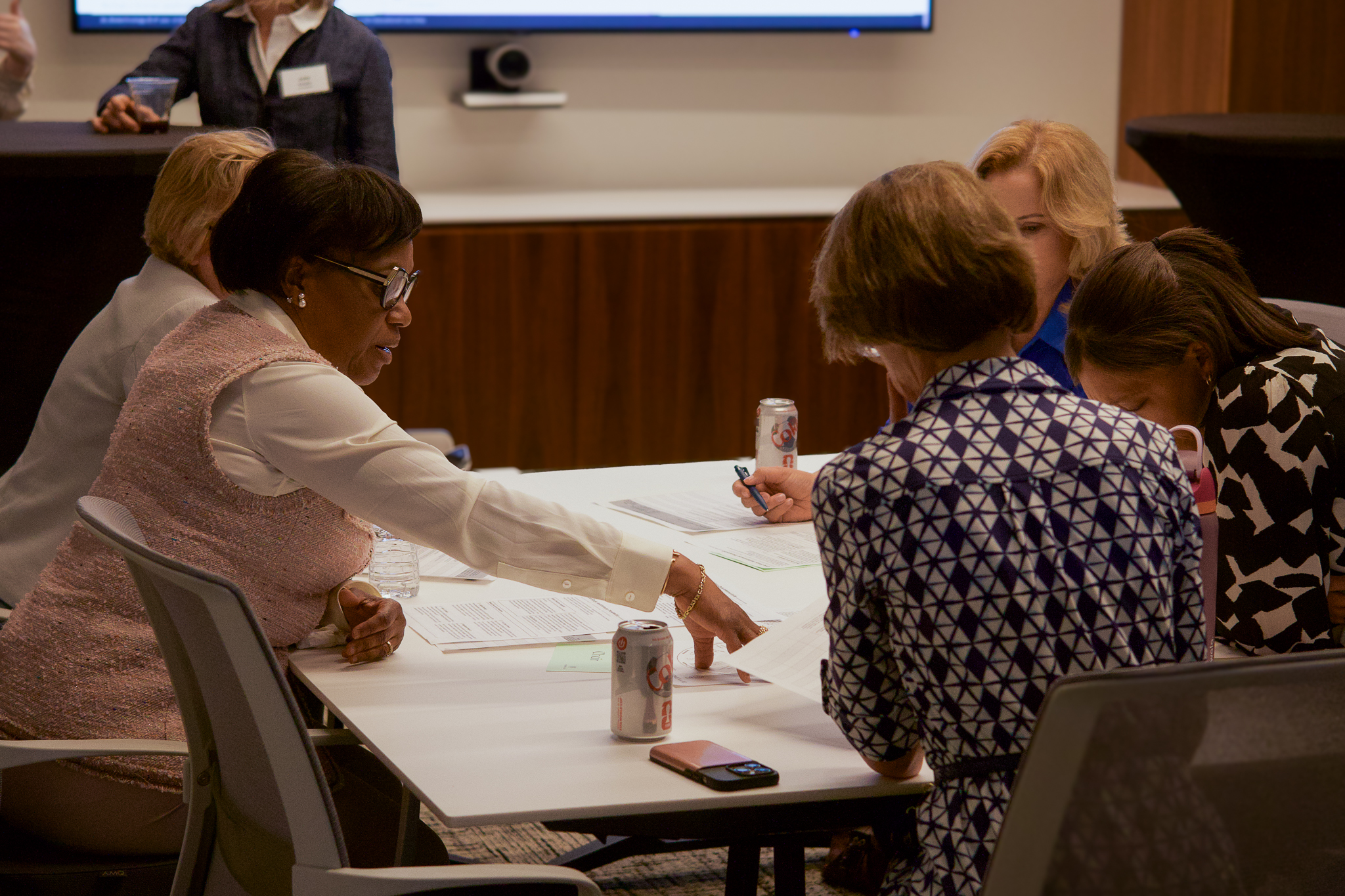 Board directors working through a governance exercise around a table